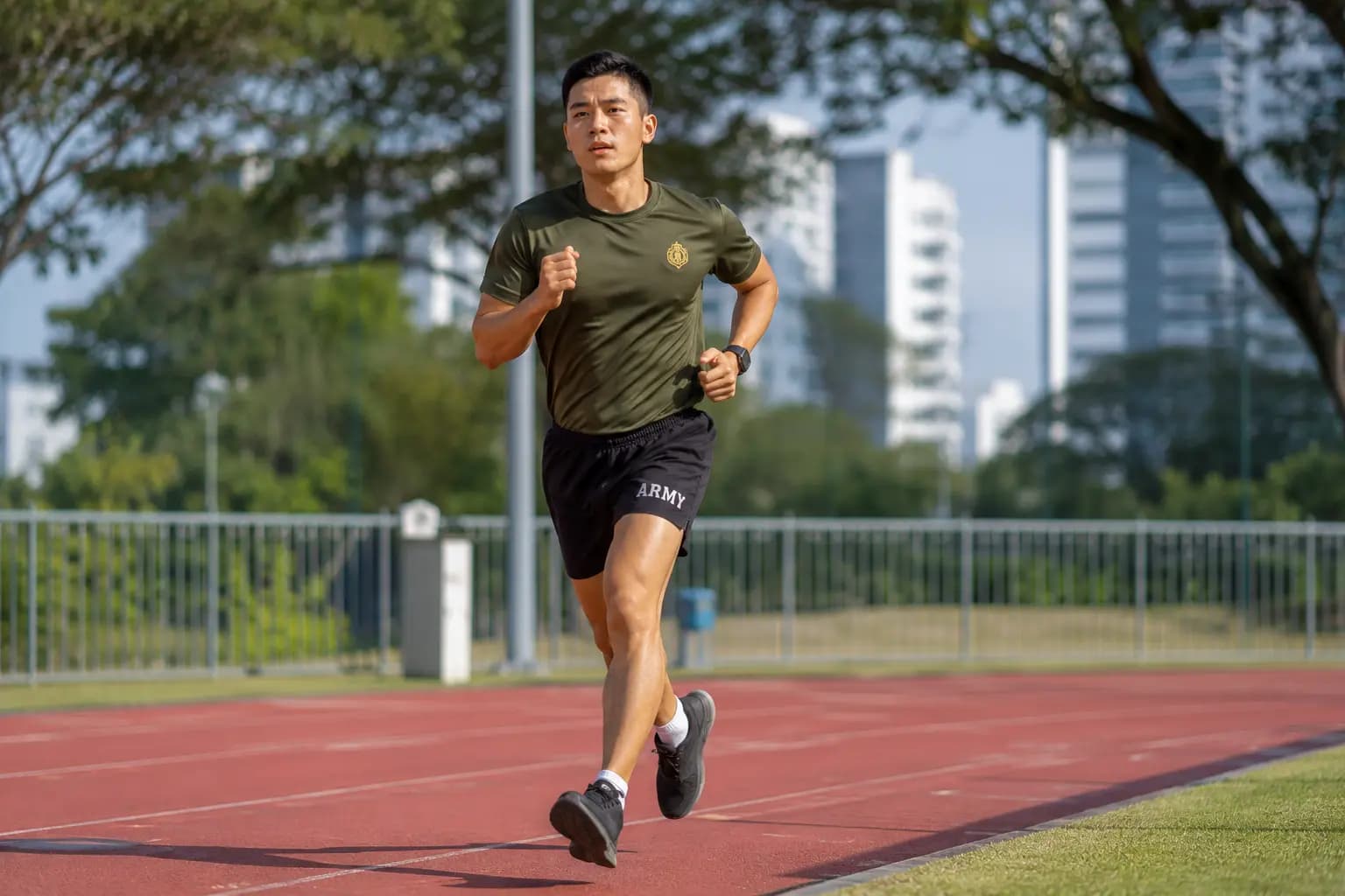 Man running IPPT 2.4km station on outdoor track